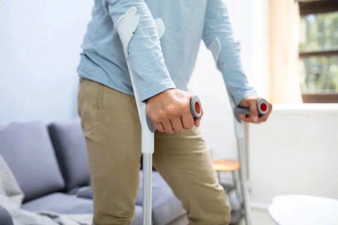 Adult Patient Walking at Home with HKAFO Support